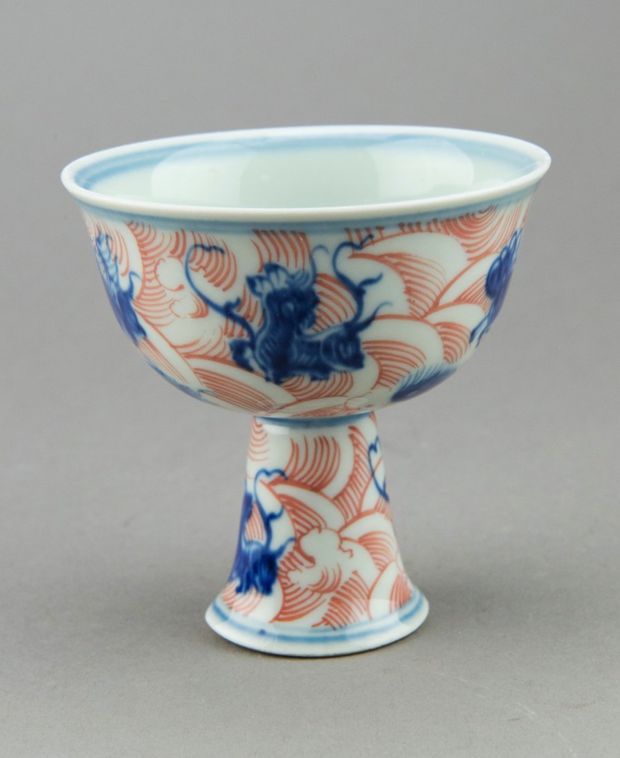 Chinese Blue & White Stem Cup w Yongle Mark: Chinese blue and white porcelain stem cup, richly decorated with blue dragons amongst red sea waves on the exterior, the interior with blue Yongle mark. H: 9 cm, D: 8.5 cm, 99 grams.