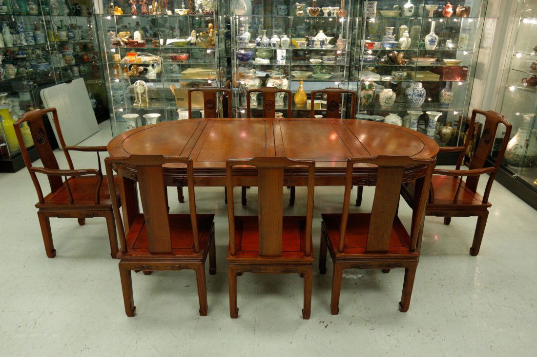 1940s Chinese Rosewood Dining Set 8 Chairs & Table: Chinese Mid 20th Century Huali Rosewood dining table set; comprised of two armchairs, six side chairs and one oval-shaped table; Side chair: H: 91.4 cm, W: 39.4 cm, L: 43.2 cm; Arm chair: H: 92.7 cm,