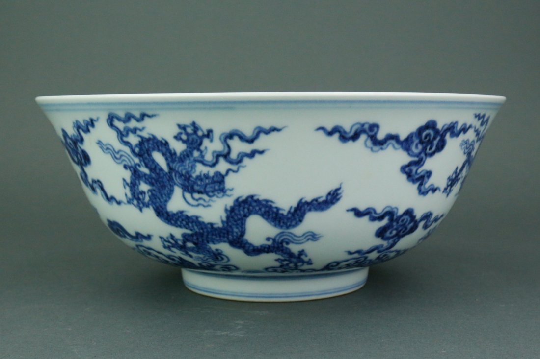 Chinese BW Porcelain Bowl with Ming Mark: Chinese blue and white bowl; supported on low foot rim; featuring dragon and clouds on body; six-character Ming Xuande with double circle mark on base; D: 23.5 cm, H: 8.5 cm 688 grams