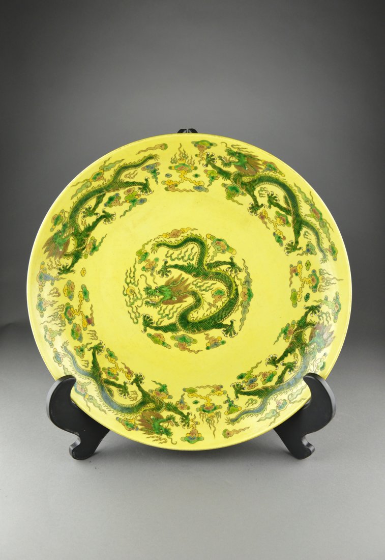 Chinese Yellow Dragon Porcelain Charger Kangxi: Chinese yellow ground porcelain charger; the centre featuring writhing five-toed dragon with cavetto decorated in the same manner; six-character Kangxi Mark on base; D: 44 cm, H: 8 cm