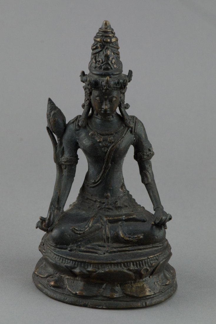 Chinese Bronze Figure of Buddha: Chinese bronze figure of Buddha; seated on lotus plinth with hands in mudra and holding a scepter; serene expression adorned with tiered crowned; H: 17 cm, W: 9 cm, 479 grams