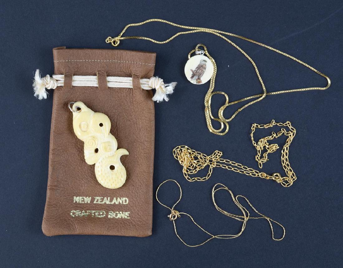 14K necklaces and carvings: New Zealand, Maori Style Bone Carving on a 14K Chain together with a Scrimshaw Eagle Bone Pendant. Three 14k Chains with a net weight of 10 Grams / 6.3 dwt. Good condition. Keywords: South Pacific, Na