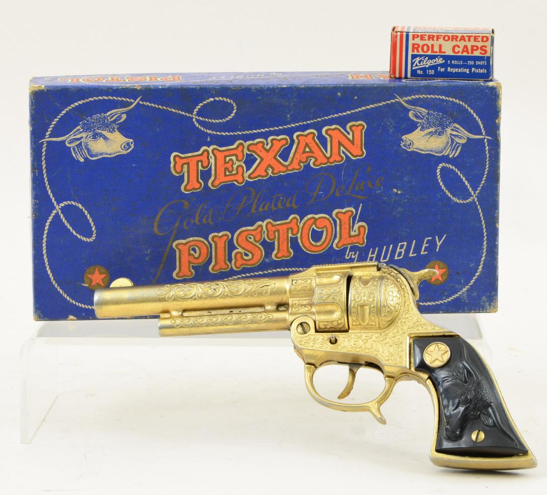 Hubley Texan Toy Cap Gun Pistol: Original Box, Texan Gold Plated Deluxe Pistol by Hubley, with Texan Jr. Piston Inside, and Kilgore roll caps. very light plate wear, some pitting at the strike plate, grips very good. Working mechanic