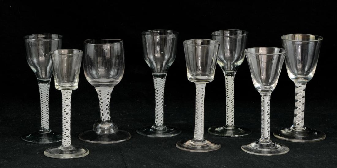 8 English Air-Twist Stem Glasses: 19th Century or earlier. White Twist Glass Wine, Cordial or Port glasses. Free Blown, Pontil marks, Each about 6" tall. A few Rough spots and dings on the bases, no chips to the rims, Overall good. Ke
