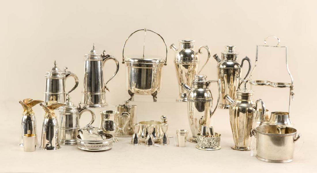 Silverplate Barware group: This group contains 5 ice buckets,2 flasks, 3 Wine bottle coasters, several jiggers, wine bottle caddy, 2 eagle goblets, 4 cocktail shakers, one of them has a road runner for a finial, this piece has