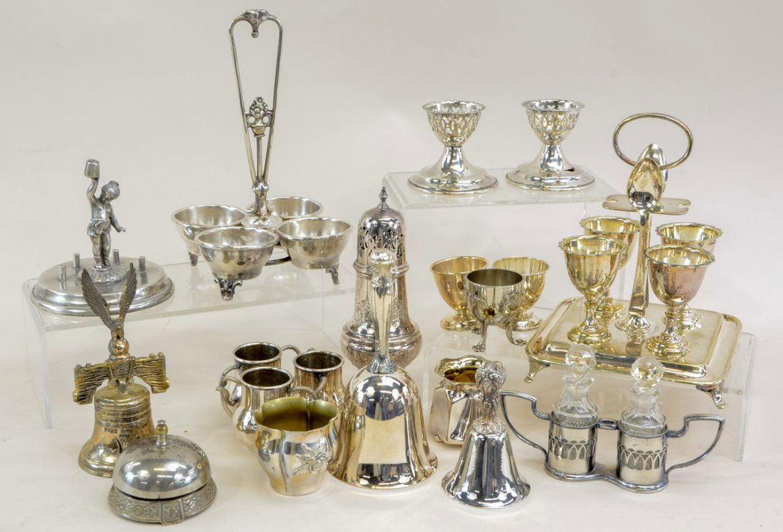 Silverplate smalls and novelties: This group contains dinner bells, counter bells egg cups , tall sugar shaker, figural thimble holder, personal size oil and vinegar set. All in good condition. Some pieces may have been re-silvered. K