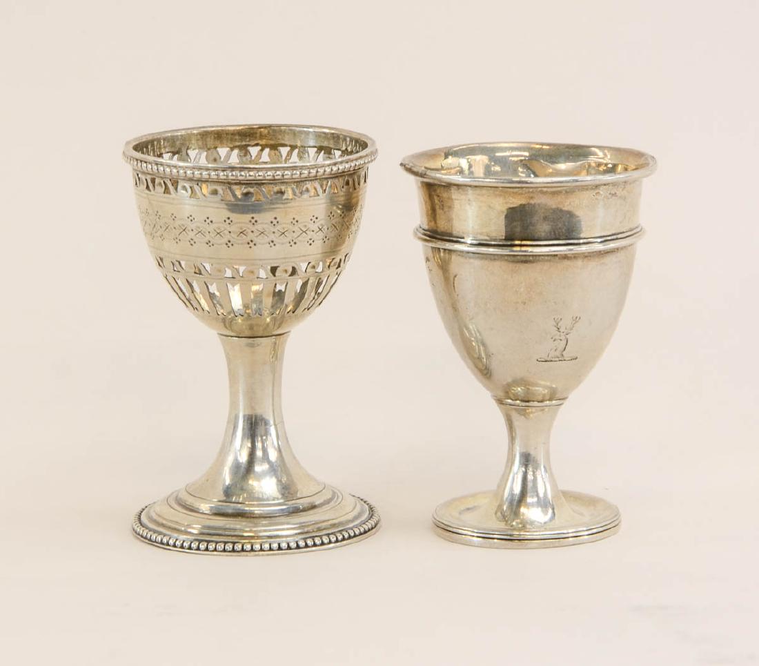Two English Silver Egg Cups: Georgian Period: A London Sterling Silver pierced Hester Bateman cup dated 1783, together with a London Sterling Silver egg cup bearing 1797 Date mark and Makers Mark HG. Each 2.75" tall, total weight