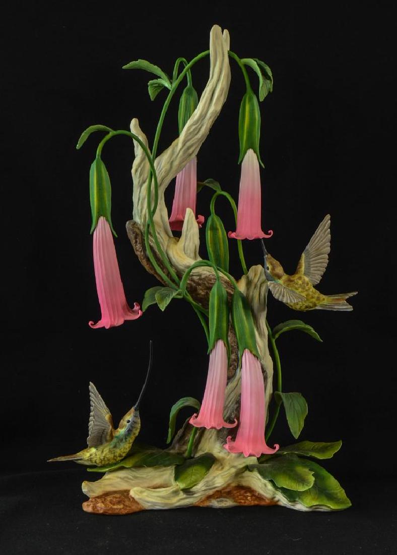 1990 Boehm Hummingbird Porcelain: Sword Billed Hummingbird with Datura, circa 1990, Figure number 10190, numbered 62, and hand signed (and presented) in sharpie. no box. One loss to leaf, otherwise good. 16" tall.