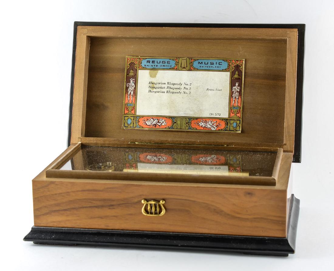 Reuge Swiss Music Box 3/72: Retailed by Rita Ford Music Boxes, New York. Inlaid Mahogany Music box with three tunes, each Franz Liszt Hungarian Rhapsody No. 2. Excellent Working Condition, all teeth present on comb. plays and ru