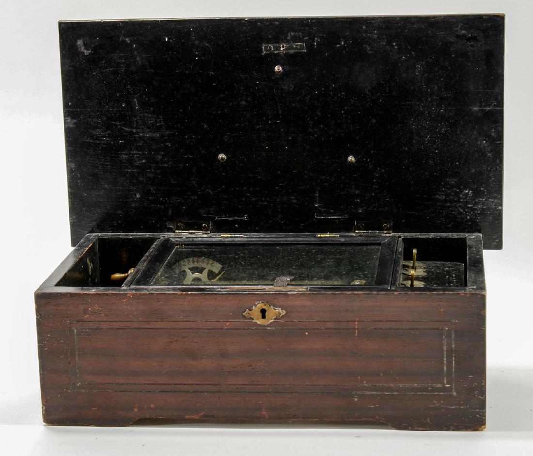 Antique Swiss Music Box: 8 Tune Music Box, running, complete. roller is damaged, one tooth on comb missing. In need of case and works restoration. Unsigned. 5.5" x 14.5" x 7.5"