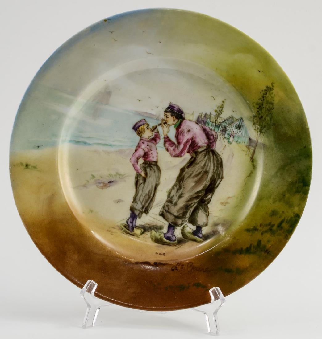Handel Ware Porcelain Plate w/ smoking scene: Antique Handelware Porcelain Plate with Hand Painted Scene of a man and boy lighting cigars. Artist Signed L.E. Claire, Green Handel Mark to base, 10" diameter, Excellent condition. Keywords: Meriden,