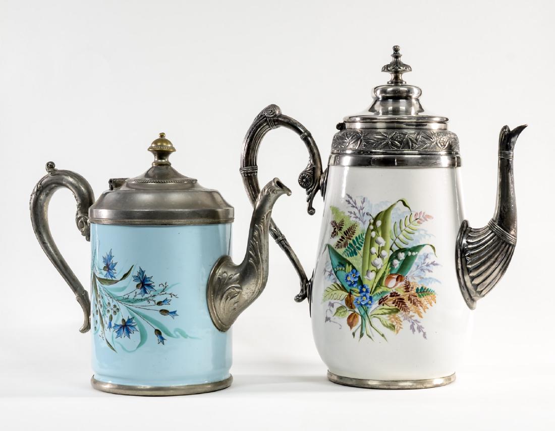 Manning Bowman Granite Ware Pitchers: Two Manning Bowman Meriden CT Enamel and silverplate / Pewter Ice-water Graniteware Pitchers with floral decoration. Minor wear and use, overall Very good to Excellent condition. The larger pitcher is