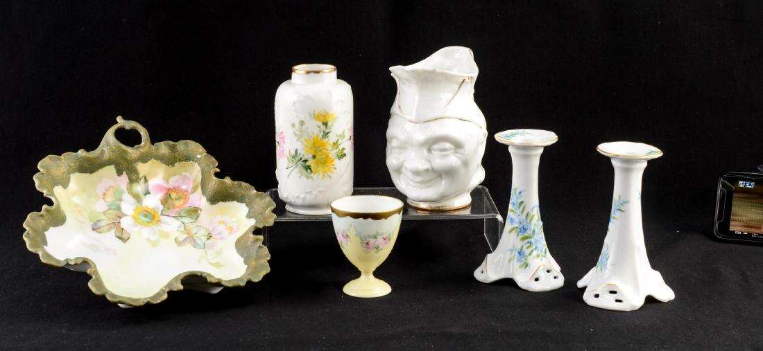 Six Pieces of Handel Ware Painted Porcelain: Lot Includes: 6" Limoges Decorated vase with Gold Handel, Co. Signature. 6" tall Face Jug (As-is condition) a single 3.25" egg or custard cup with gold Handel signature, a pair of Austrian Porcelain B