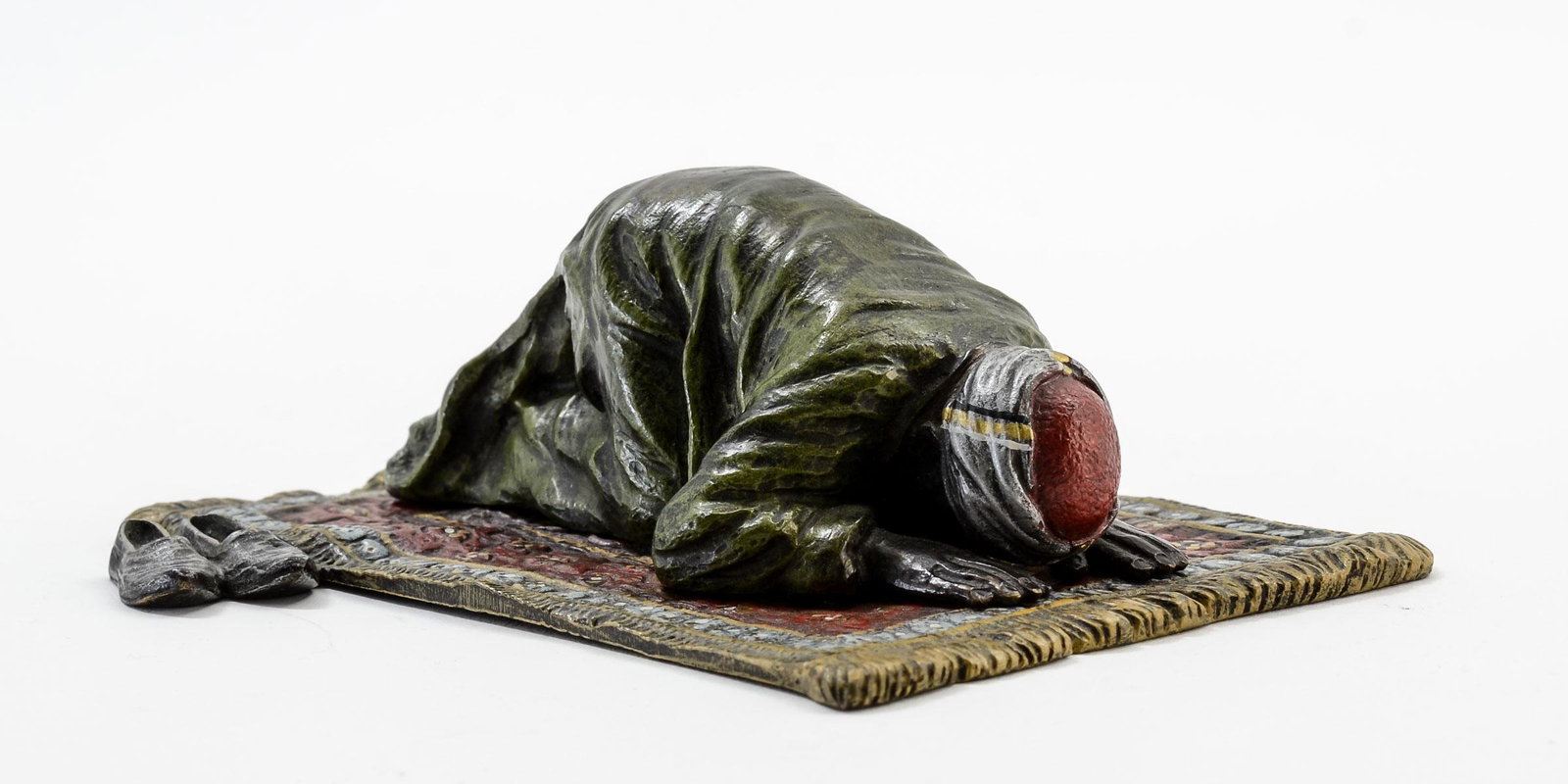 Franz Bergman Bronze: Man Praying: Cold Painted Austrian Bronze Figure of a Man on a Prayer rug. Figure is removable by design, and the detail on his face is excellent. Base is Signed with "B" in vase mark and AUSTRIA, Figure has a sta