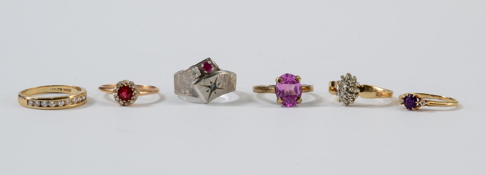 Six Ladies Estate Rings: Estate Fresh Fine Jewelry Rings all set in 14K White and yellow gold. Including Diamonds, Rubies, Pink Topaz, etc(Channel Set Wedding band is CZ)size and condition vary. 11.8 dwt / 18.4 grams.