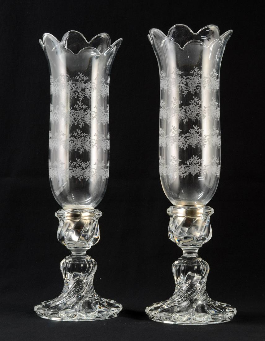 Pair of Baccarat Crystal Candlesticks: Etch Hurricane Shades and twist-form Bases both signed. Each 16" x 5". One base has a repair to the metal collar inside base. No Chips or cracks. Keywords: French, France,Lamp, Lighting, Candle