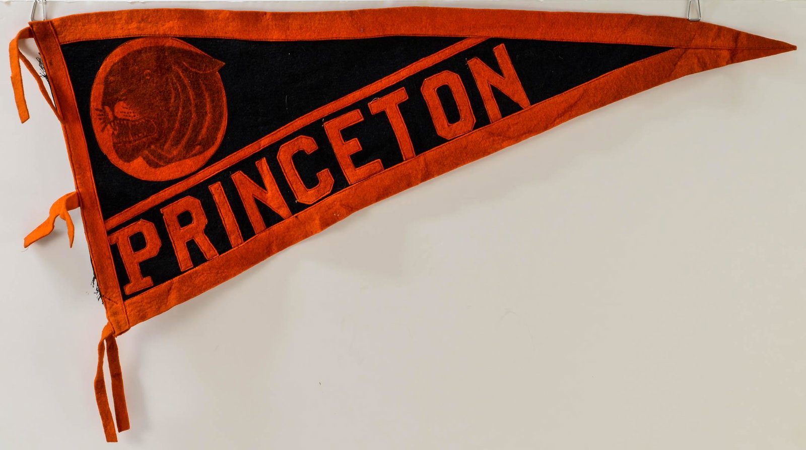 Two Princeton Felt Wool Pennants: Two Felt Wool Tiger Pennants from Princeton University. First Half 20th Century, Transfer and Sewn Decorations. The largest 33" x 14". Some wear and a few moth bites, overall good. Bright colors. Keyw