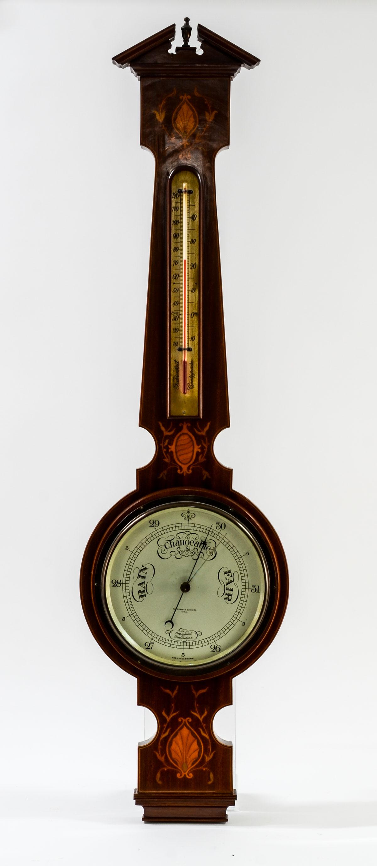 English Inlaid Mahogany Banjo Barometer: Mercury Thermometer and Barometer signed Harvey Lewis and Made in Great Britain. Very good condition, patina to metal surfaces, Original finish on wood, With 1914 patent date. 38.5" x 10" x 2.5"