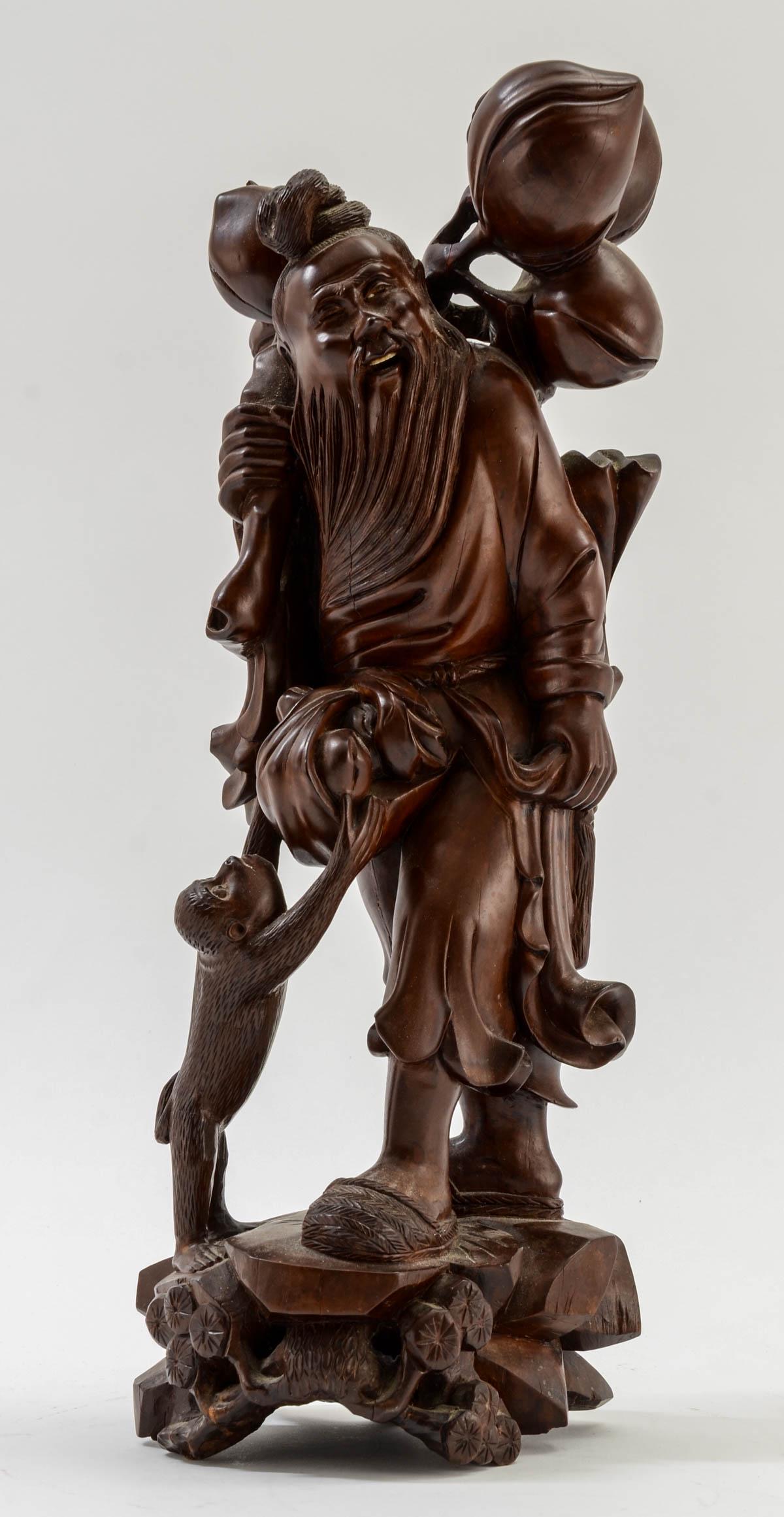 Chinese Wood Carving: Man & Monkey: Well Carved Man with a Monkey stealing fruit from his bundle. Glass eyes, not present in man, but present on monkey, The man has bone teeth. Late 19th or early 20th Century. Settled dust and patina. 1