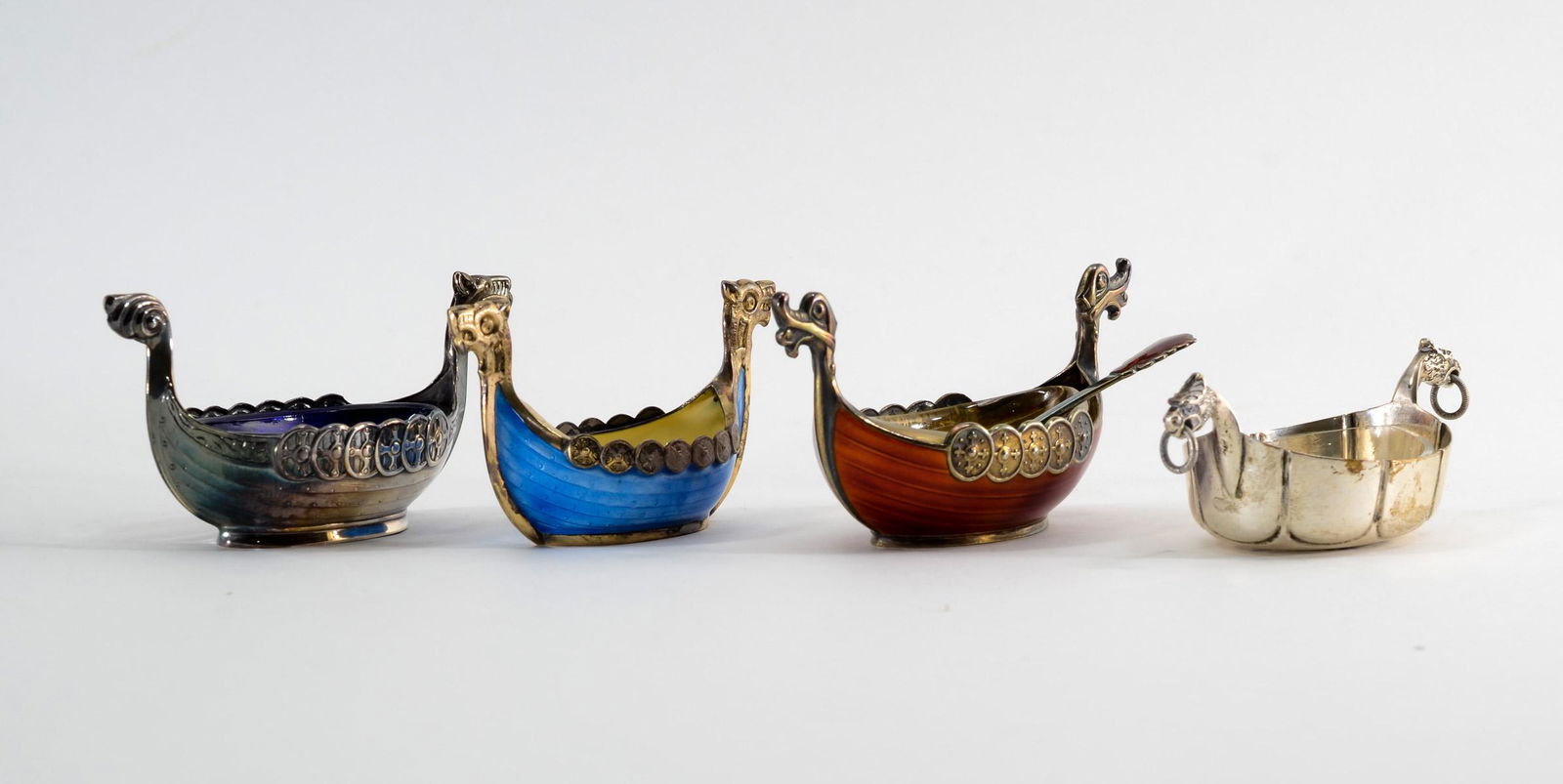 4 Scandinavian Sterling Viking Ship Open Salts: Four Scandinavian sterling silver Viking ship open salts. Total weight, not including inserts: 3.20 troy ozs. Including: 1 - Theodor Olsen red enamel over sterling with clear glass insert and matching