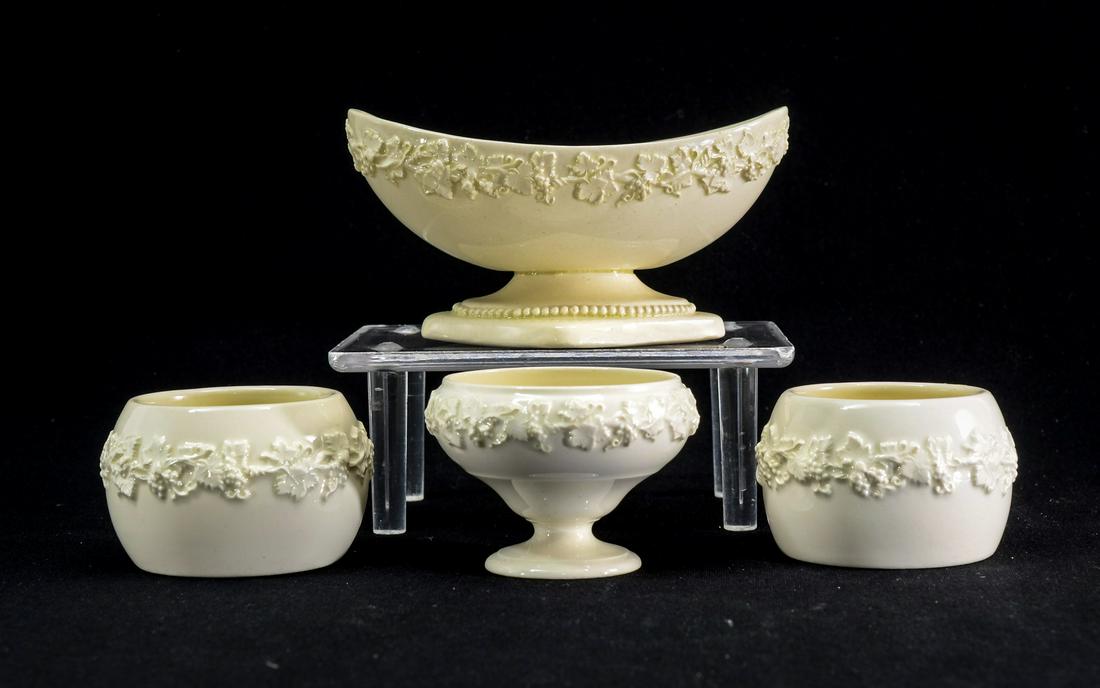 4 pcs wedgwood Queensware: This group of open salts includes a boat shape master salt measuring 4" long by 2" tall, The other 3 pieces are 2" wide by 1 1/2" tall. All in excellent condition free from cracks, chips and repairs.