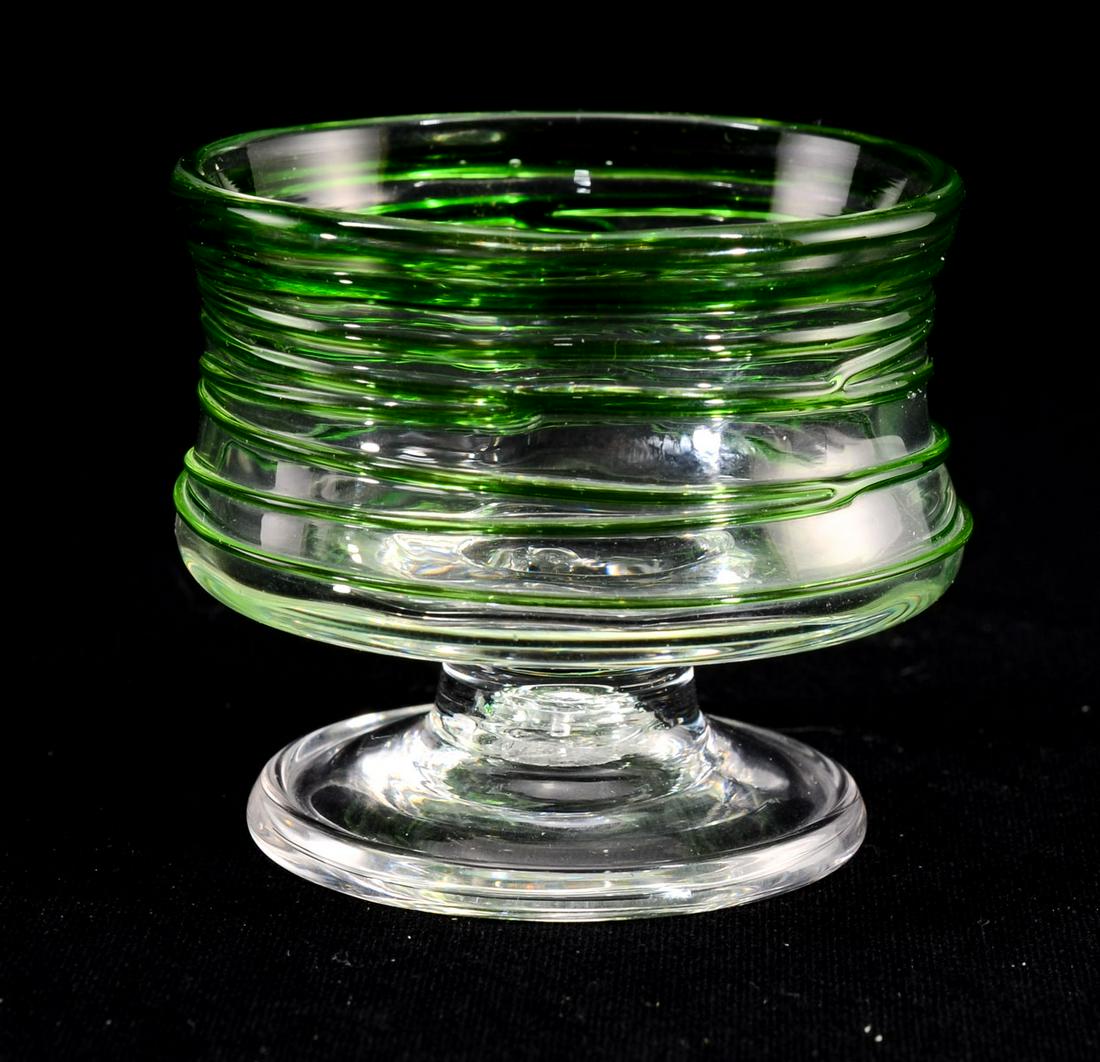 Steuben Threaded Glass Open Salt: Pedestal Form, Green threads over clear glass. Hand Blown, pontil mark, STEUBEN Acid mark to base. 2" x 2" excellent condition. Keywords: Antique, American, Art Glass, Salt Cellar