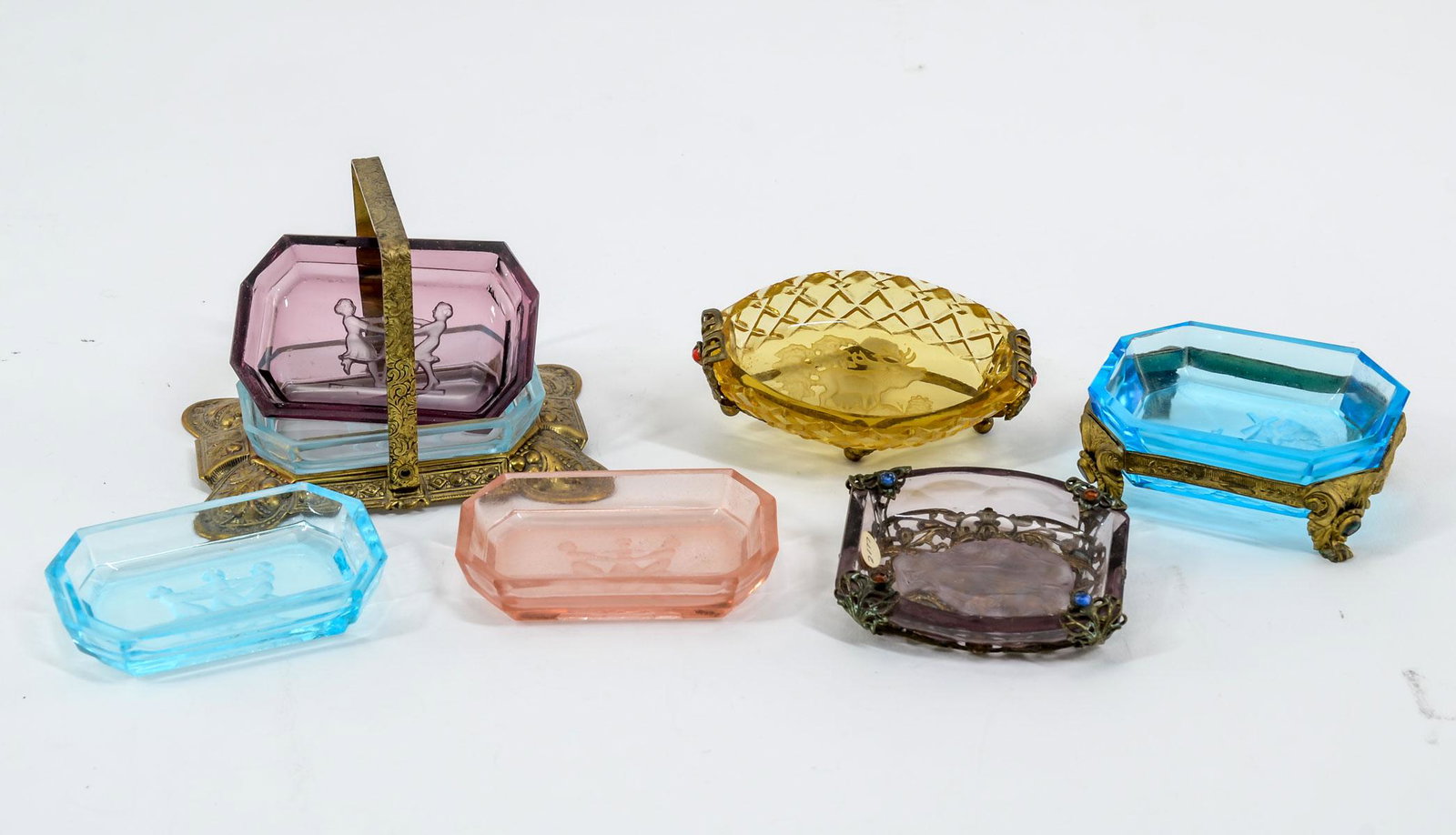 3 Intaglio Glass Salts in Frame, 1 Set in Frame: Three intaglio cut glass salts in gilt metal frames. Including: 1 - Set of four colored Classical scene salts in embossed gilt frame. 2 5/8" high x 2 1/2" wide x 3 3/4" long. Some rim flakes on salts.