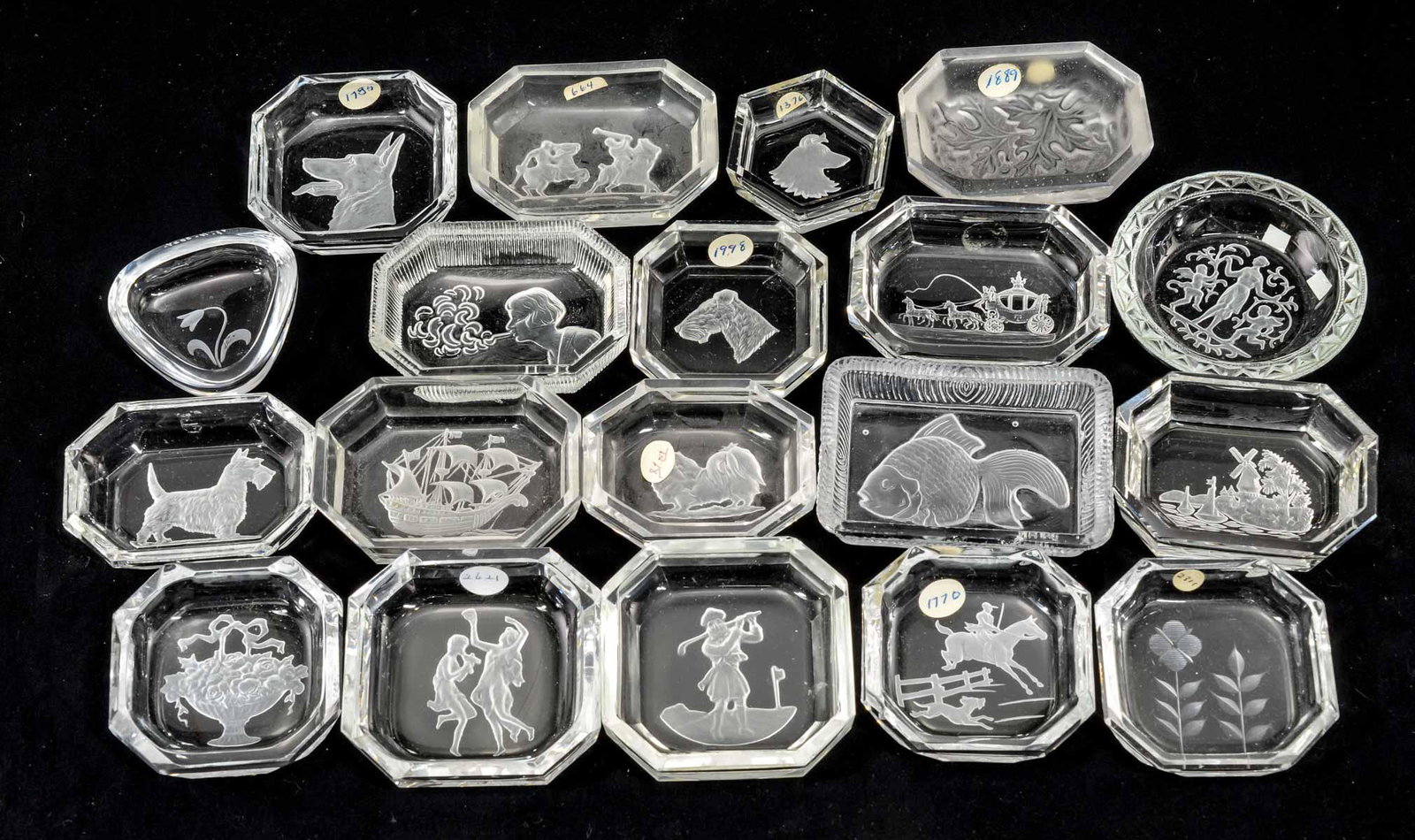 19 Clear Intaglio Glass Open Salts: Nineteen clear Intaglio cut glass open salt. Subjects Include: Lady smoking, stagecoach, Dutch windmill scene, Classical, goldfish, Scotty dog, dog heads, ship, small breed dog, floral, oak leaf and p