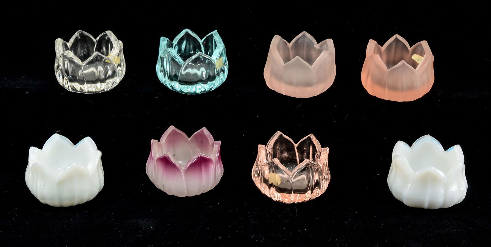15 Colored Glass Lotus Open Salts: Fifteen colored glass lotus form open salts. Colored include: Green, cobalt, clear, black, milk, pink, amber, shaded pink. All appear to be in good condition, not inspected individually. Keywords: Sal