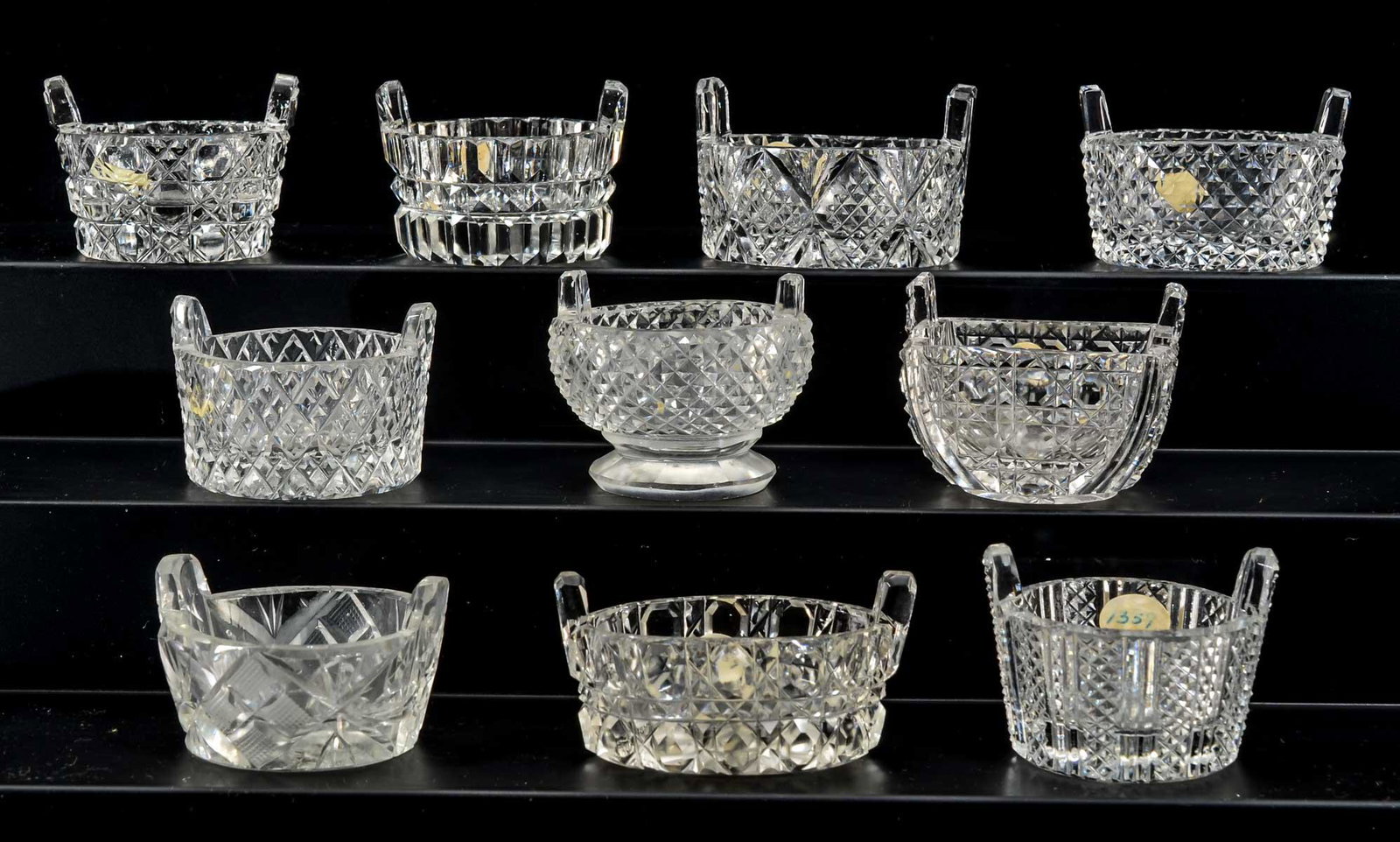 10 Cut Glass Bucket Form Open Salts: Ten clear cut glass Bucket form open salts. Various patterns. Unmarked. All appear to be in good condition, likely some with small rim flakes, not inspected individually. Keywords: Salt Cellar, Salt D