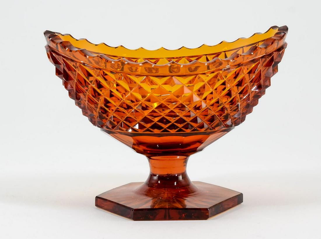 Amber Cut Glass Pedestal Master Salt: Amber cut glass pedestal boat form open master salt. Diamond point style pattern with serrated edge. 3 3/4" high x 3 1/4" wide x 5 1/4" long. In very good condition. Keywords: Salt Cellar, Sat Dip, Am