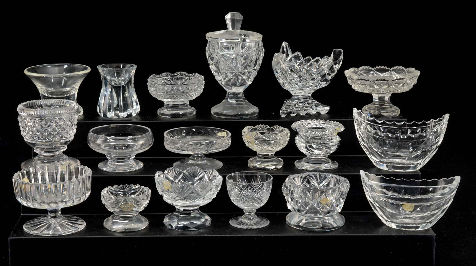 18 Clear Cut Crystal Open Salts: Eighteen clear cut crystal open salts. Various patterns, shapes, makers and ages. All appear to be in good condition, not inspected indivually. Keywords: Salt Cellar, Salt Dip, American, European