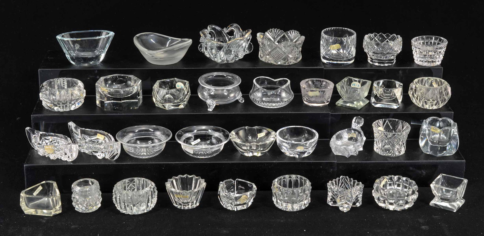 34 Clear Crystal Open Salts: Thirty four clear crystal open salts. Better quality, various patterns, shapes, makers and ages. All appear to be in good condition, not inspected individually. Keywords: Salt Cellar, Salt Dip, Americ
