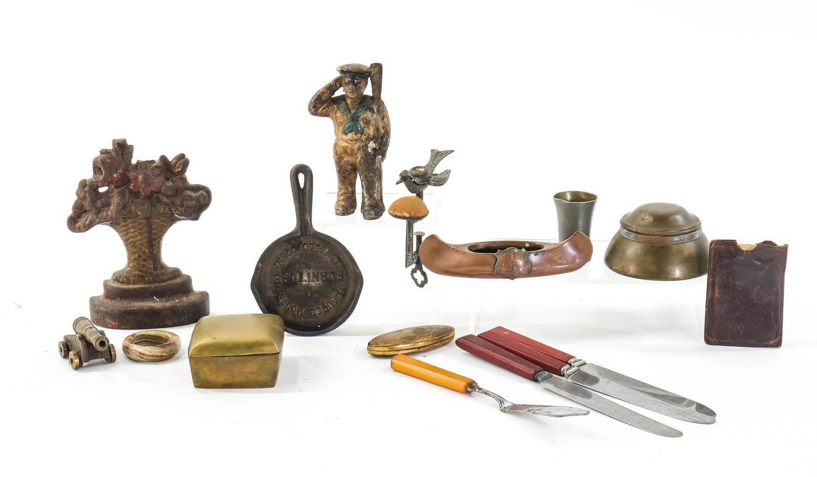 Excellent Smalls Group: Cast Iron and more: includes a cast iron miniature advertising frying pan, Brass Box, Inkwell, pewter, Cast metal souvenir canoe, German silver coin purse, Victorian Sewing Bird, bakelite handle knives, Antique Railroad 