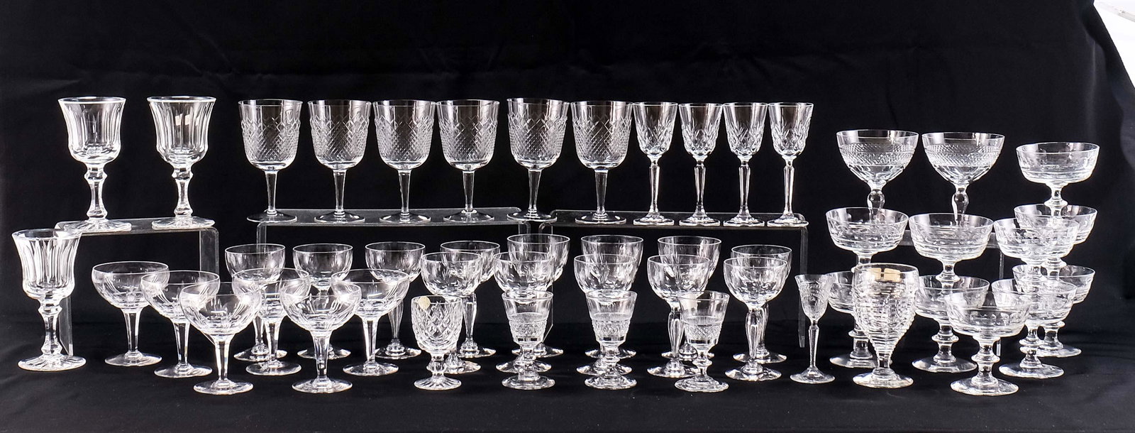 50 Assorted Glass Stems: A group of wines, cordials, champagne. This group includes early Waterford, Tiffin, Stuart, Webbs England Tiffany & Co. Minimal to no shelf wear all are free from chips, cracks and repairs.Keywords: I