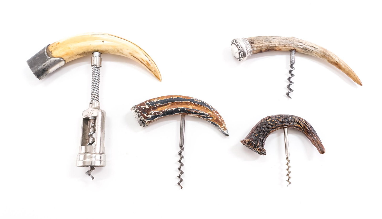 4 Horn and Sterling Corkscrews: A large tusk handle embellished with sterling silver, 6 1/2", 2 horn also embellished with sterling silver, 1 faux horn embellished with sterling silver.Keywords: bar ware, horn, bone, wine, Cork, Scr