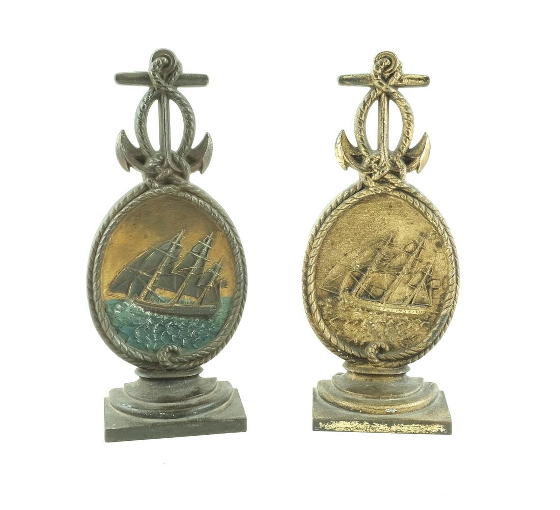 2 Bradley & Hubbard Nautical Doorstops: Two nautical / maritime doorstops by Bradley and Hubbard. Meriden, CT. Cast iron. Both show sailing ships in a storm, within a rope oval. Atop each is an anchor. Both marked "B&H". Different finishes