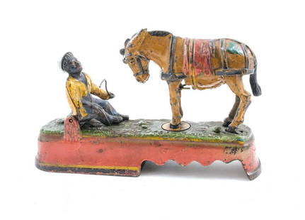 American Cast Iron Bank - Always did 'spise a Mule: Antique Black Americana cast iron bank with a mule that kicks a young boy, marked "Always did 'Spise a Mule". Patent date 1897. American, late 19th century. A button below the mule on the base