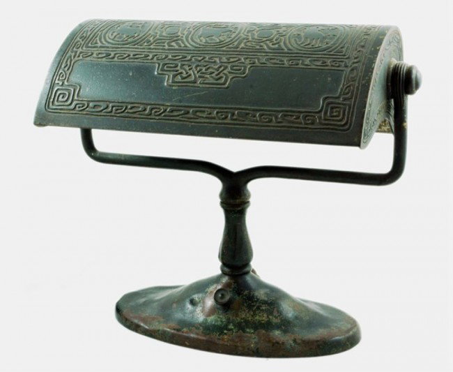 Tiffany Studios Zodiac Bronze Desk Lamp: 9" T x 11" W, Signed on the bottom edge of the base: TIFFANY STVDIOS NEW YORK 414. Cord not original. This lamp exhibits moderate to heavy wear to finish on high edges and to base. This lamp is origin