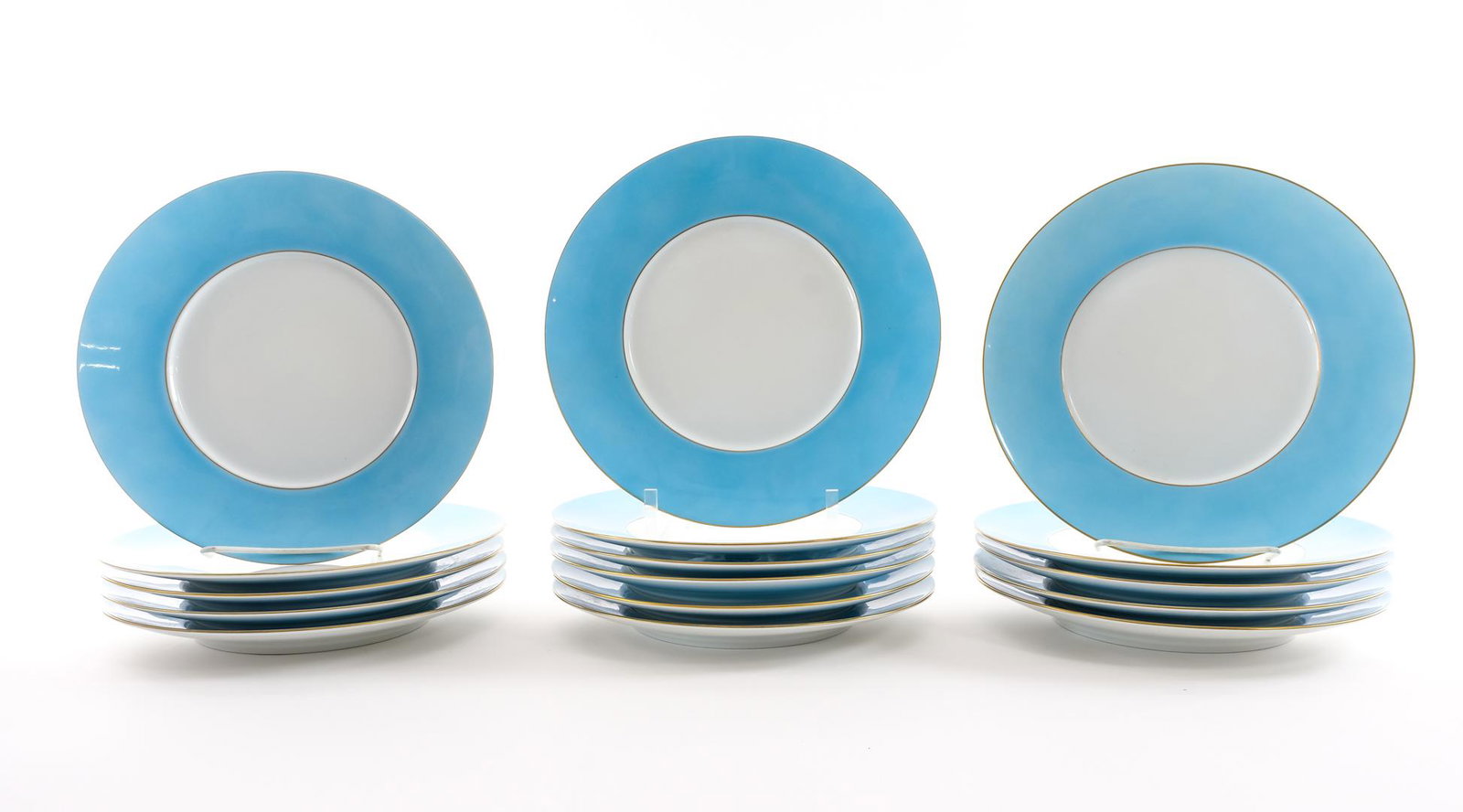 16 J.L. Coquet Dinner Plates and Bowls - Blue: Set of 16 porcelain dinner plates and bowls by J.L. Coquet of Limoges, France. 8 plates and 8 bowls. French, contemporary. White porcelain with white center, light blue lip / border with gilt trim, an