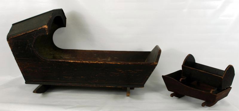 An Antique Painted Cradle and two doll cradles: Traces of old paint left inside the full size cradle: 45" x 26" x 26", each doll cradle approx 14"