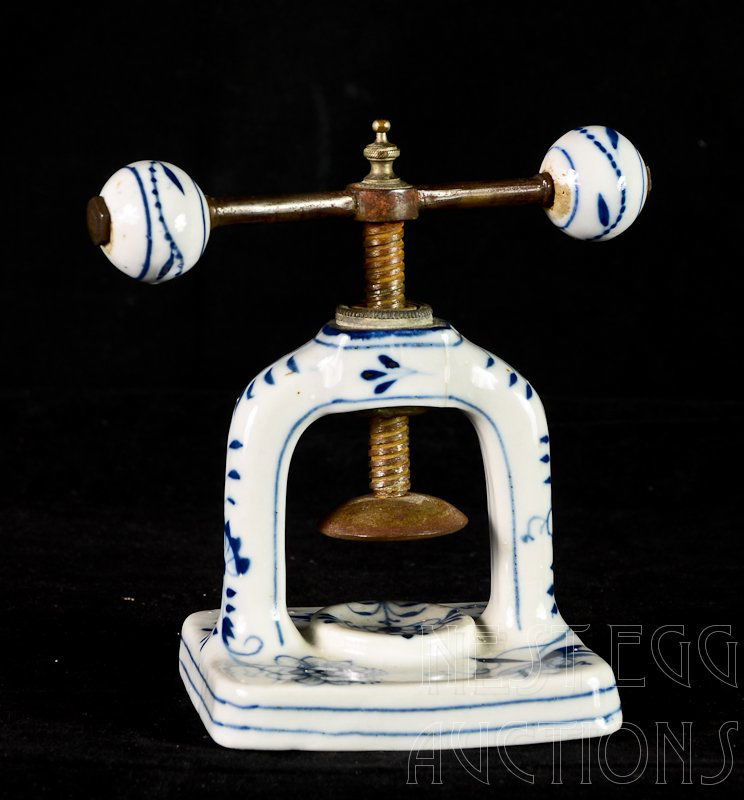 Meissen Blue Onion Porcelain Nut Cracker / Press: most likely 19th Century. Unmarked, Hand forged steel screw and hardware. two fine, tight lines at the top of the arch. Base and handles excellent. approximately 6" x 6"