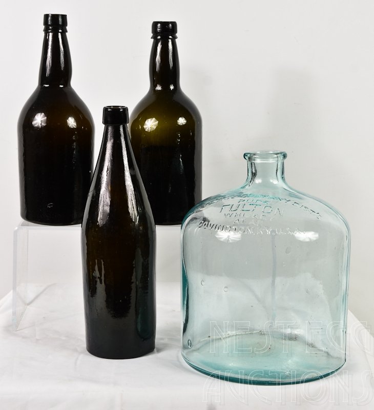 Group of four antique whiskey bottles: Three dark green hand blown bottles each approx: 11" tall, and one Myers & Company Dist's PURE FULTON Whiskey Covington KY, USA jug: 9.5" x 7.5" all in excellent condition.