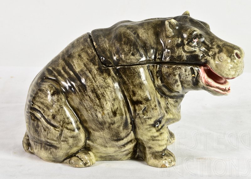 Majolica Figural Tobacco Humidor Hippopotamus: This cute Hippo stands 5" tall and 8" Long. Impressed Marks on bottom: 6029, 77. Minor chipping to the toes, ears and lid rim.