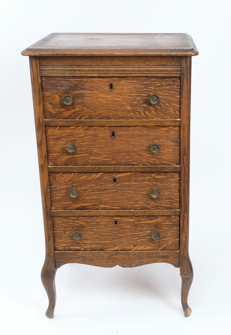 100-Cylinder Record Cabinet: Manufacturer unknown. Piece contains four pull-out drawers, each with hubs accommodating 25 cylinder recordings each. The drawers have locks but the key is missing. Oak finish appears original and exh