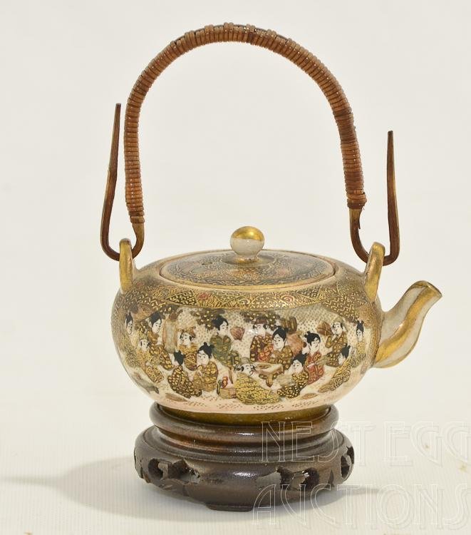 Miniature Japanese Satsuma Teapot 19th Century: Satsuma teapot in miniature with rosewood base. Beautiful teapot with precise artwork. Minimal paint loss consistent with shelf wear and age. Uniform crazing inside and out, and on the lid. No visible