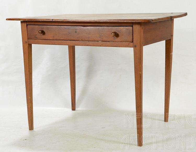 Country Hepplewhite New England Table One Drawer: Country Hepplewhite table. Pine. New England origin. Tapered legs. One drawer with two wooden pulls. Two board top. Old refinish. Early 19th century. 30 H x 39 W x 28 D. Appropriate wear.