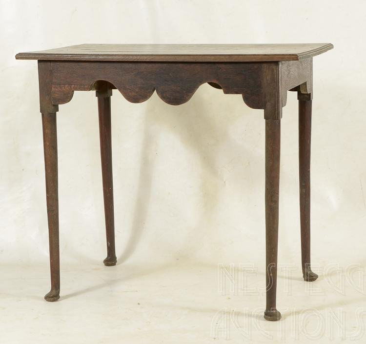 Queen Anne Style English Tavern Table: English Queen Anne style tavern table. Oak. Rectangular thumb-molded top rests on deep scalloped apron raised on cylindrical tapered legs terminating on pad feet. 19th century. 27 3/4 x 31 W x 19 D. A