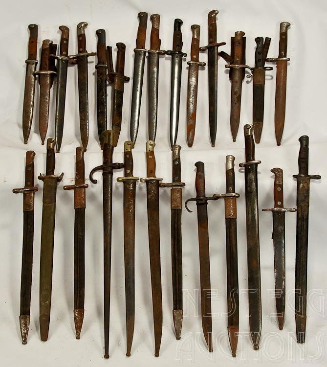 Assorted Military Bayonet Group Of 26: Group of 26 assorted military bayonets. Condition and lengths vary. Fair condition overall with no shortage of rust. Not all scabbards match the bayonet they house. WWI & W