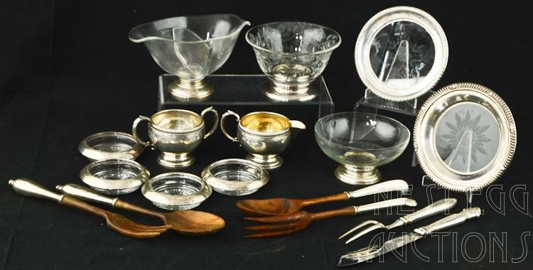 16 Piece Weighted Sterling Lot: 16 Piece lot of weighted sterling. Lot includes wood and sterling serving pieces, glass and sterling silver coasters, trivets, bowls and dishes, and single weighted pieces. Makers include: Webster, Fr